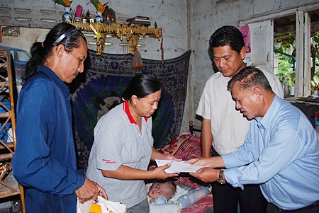 Sattahip officials donated cash, food and diapers for 16-month-old Nathakorn Sae-Chua.